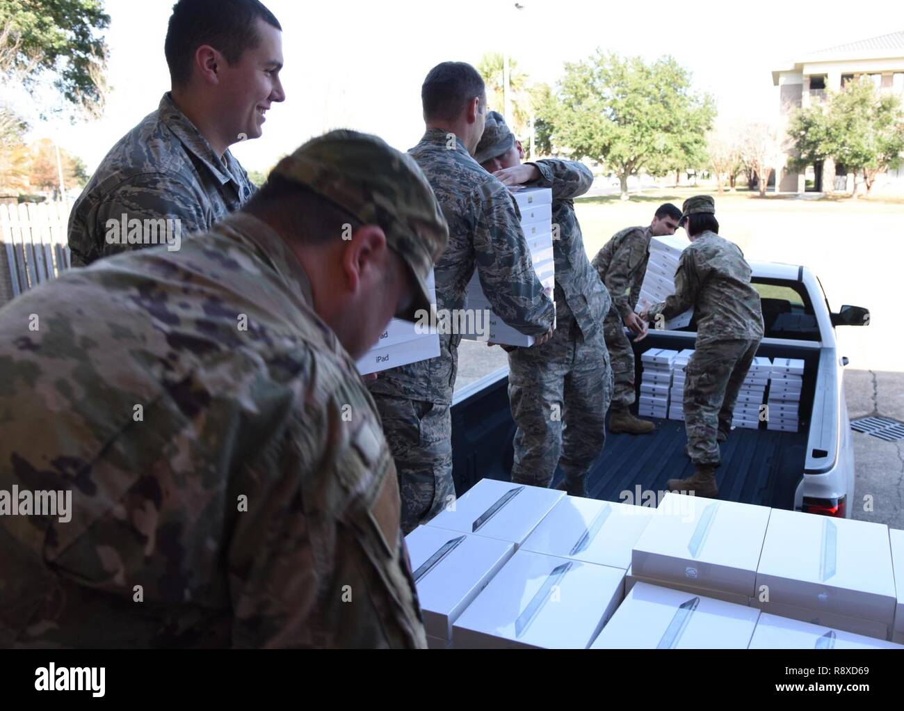 Members of the 81st Communications Squadron load 200 iPads on a truck for transporting at Keesler Air Force Base, Miss., Dec. 6, 2018.  The 81st CS joined efforts with its honorary commander, Jade Ferguson, Mississippi Public Service Commission, Southern District district director, in identifying a school in need. Through this community partnership 200 iPads, valued at $72,000, were donated to the pre-kindergarten though second grade school for the opportunity of exploring science, technology, engineering, and mathematics (STEM). Stock Photo