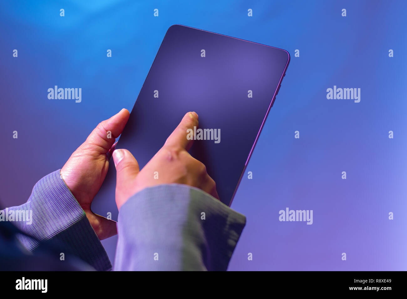 Touch digital tablet with pointer finger for browshing. Smart technology for business concept. Isolated on bluish. Stock Photo