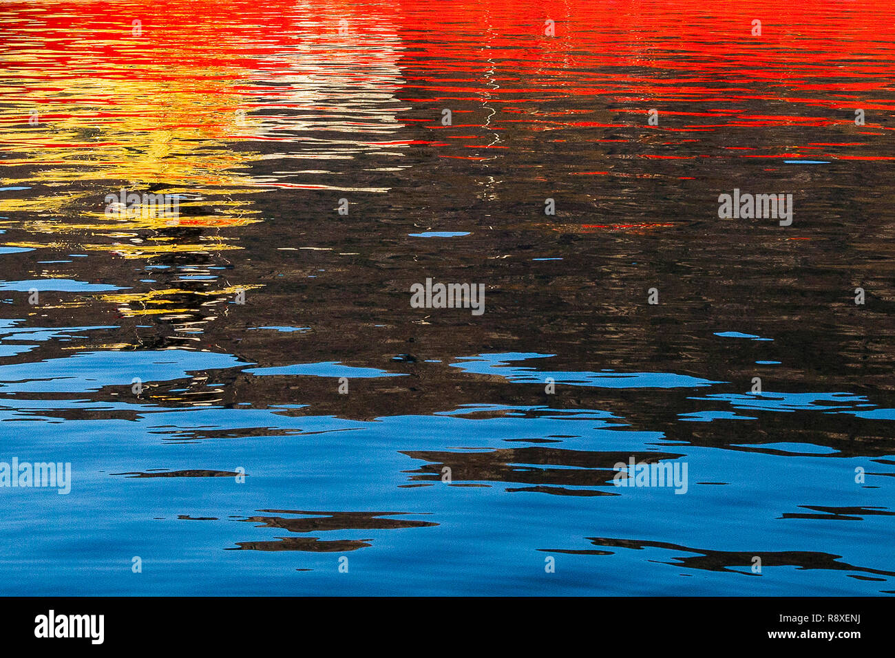 Reflections from a ship throwing interesting patterns on the water Mirror image on water. Stock Photo