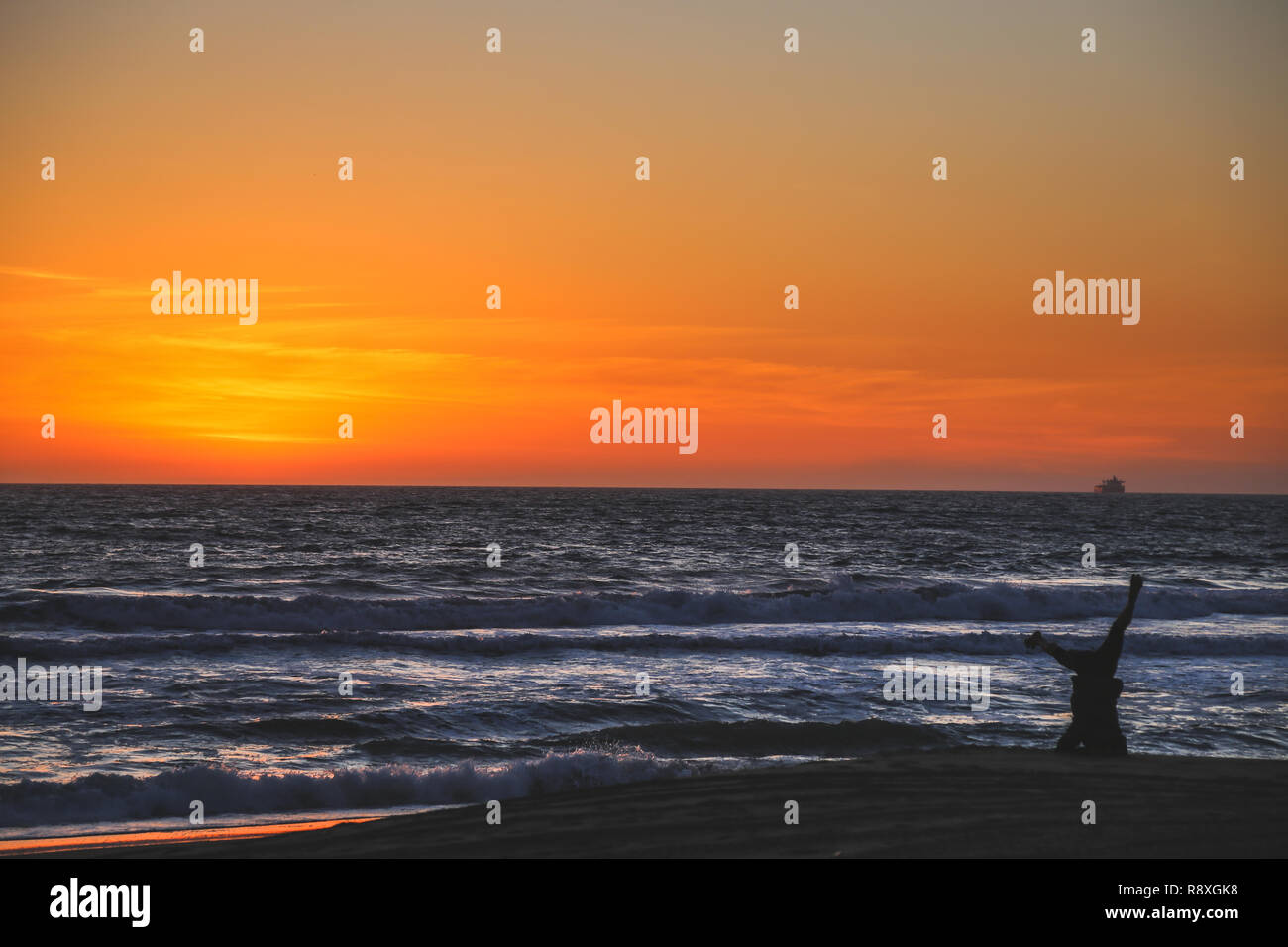 girl doing yoga on the beach at sunset on hermosa beach in los angeles