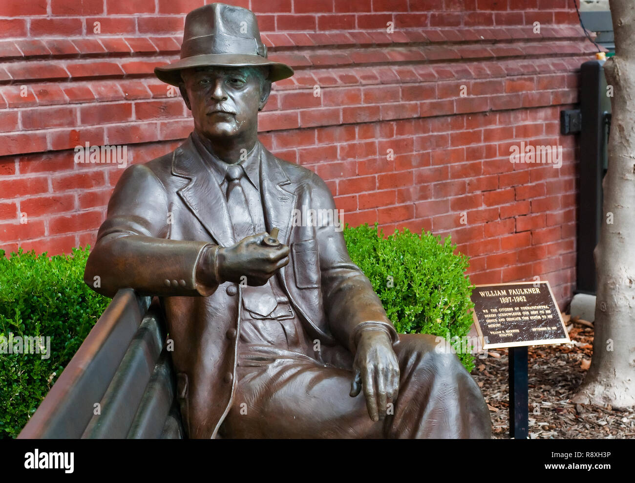 A bronze statue of William Faulkner looks out over Courthouse Square, July 17, 2011, in Oxford, Mississippi. Stock Photo