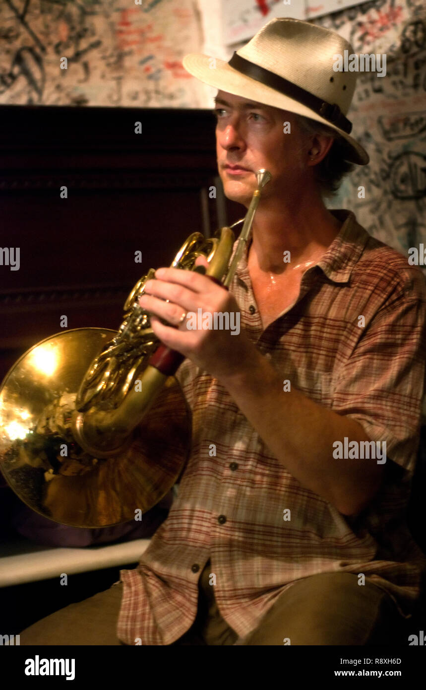 A musician plays a trumpet as diners eat at Taylor Grocery, July 31, 2011, in Taylor, Mississippi. Stock Photo