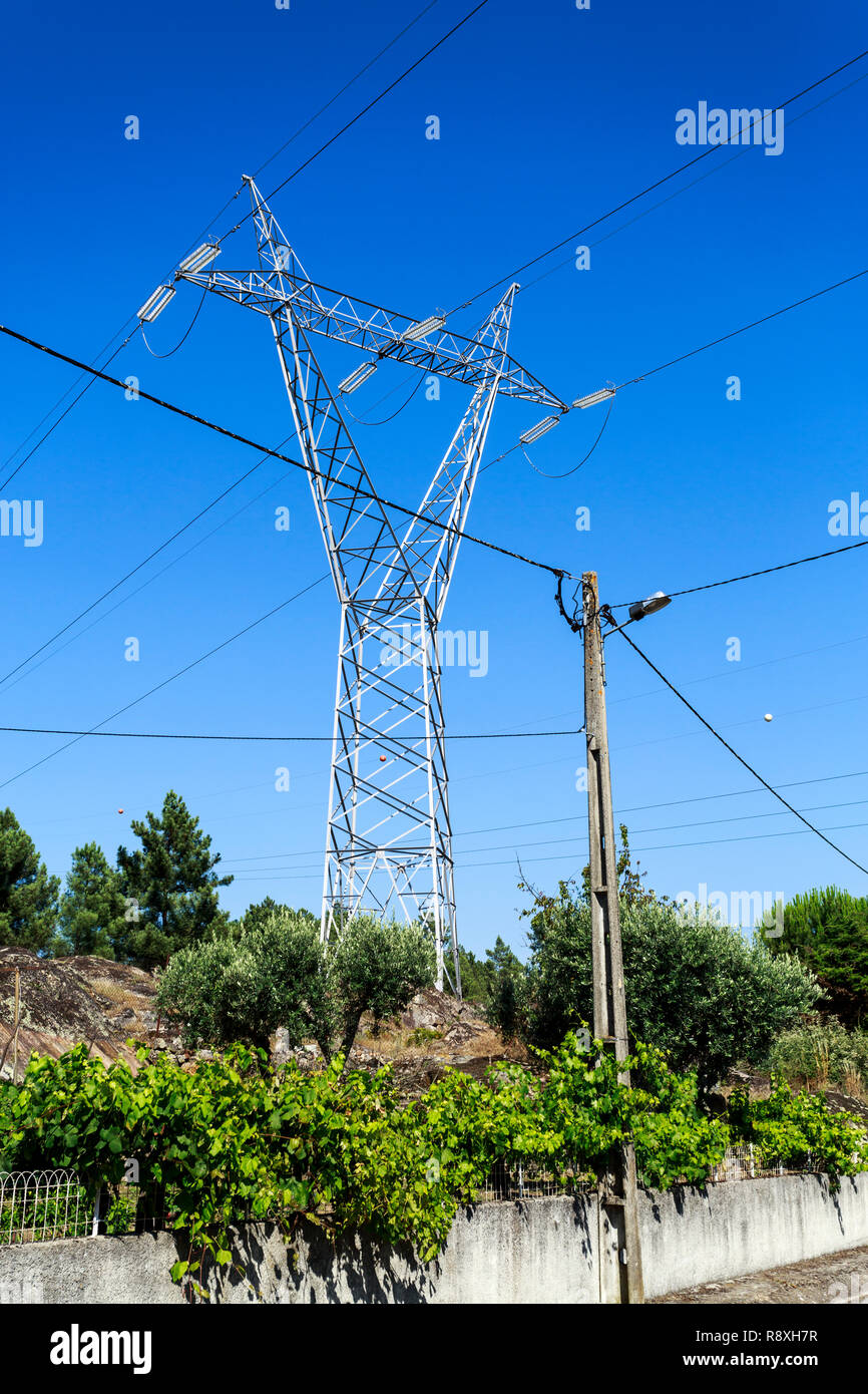 A long distance transmission tower made of steel lattice and a reinforced  concrete pylon for local supply of electricity Stock Photo - Alamy