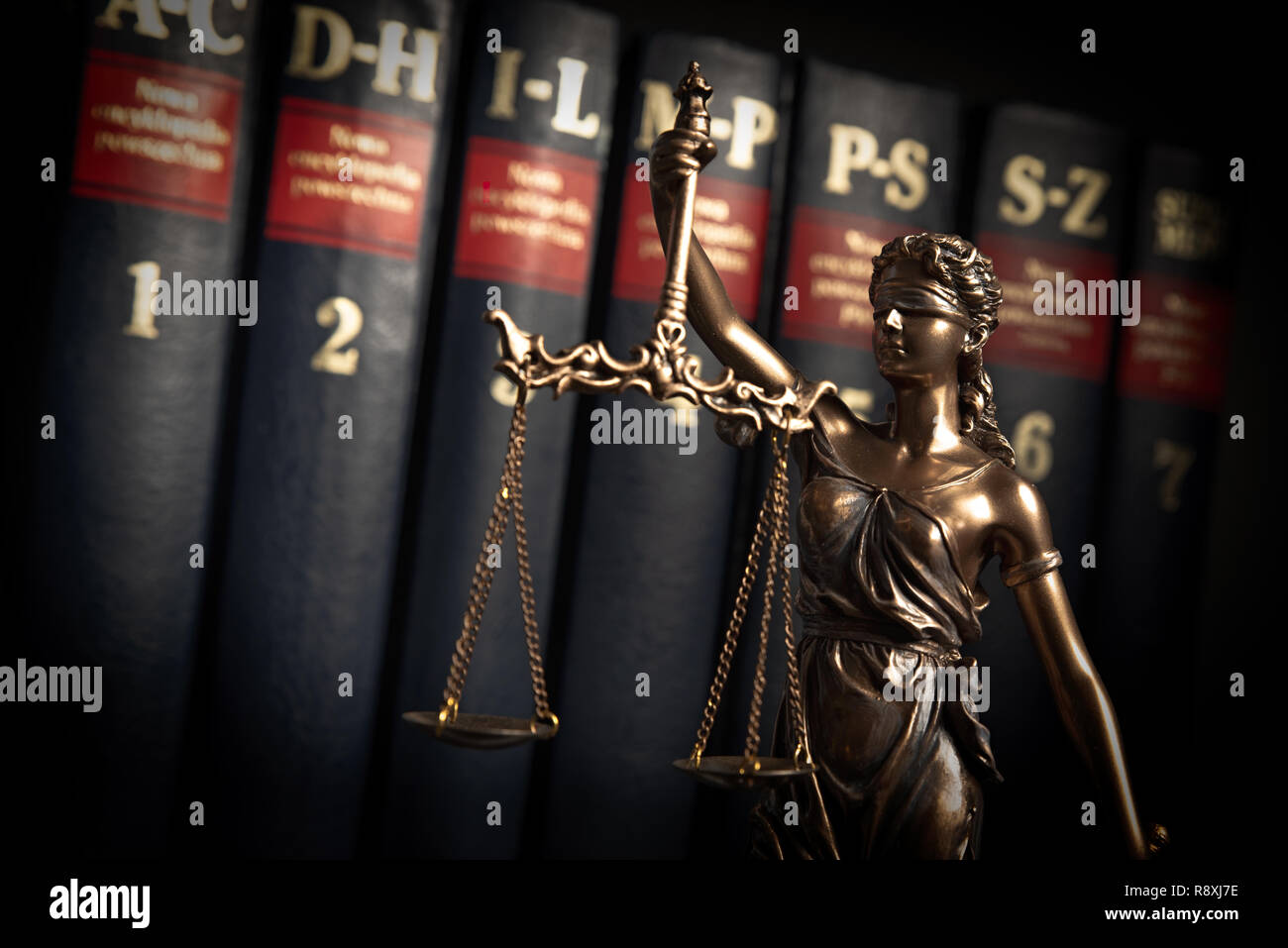 Lady justice, themis, statue of justice on books background. Law concept with justice figurine in library Stock Photo