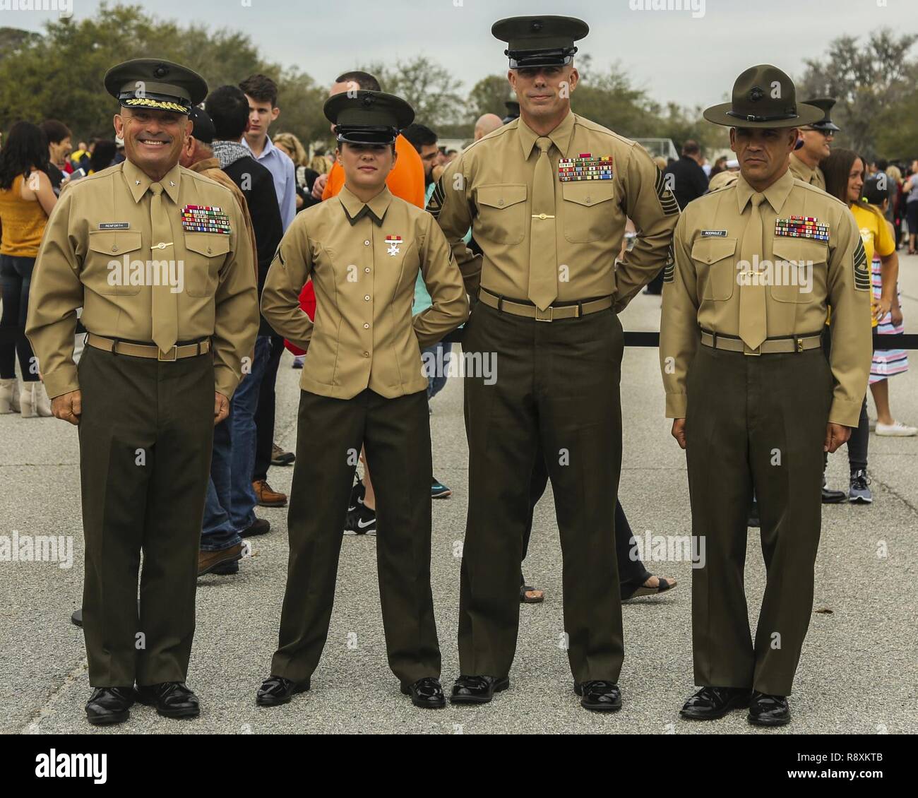 (From left to right) U.S. Marine Corps Brig. Gen. Austin Renforth, commanding general of Marine Corps Recruit Depot Parris Island/Eastern Recruiting Region, Pfc. Madeline Kreamer, Sgt. Maj. Howard Kreamer, the sergeant major of 2nd Marine Aircraft Wing, and Sgt. Maj. Rafael Rodriguez, Marine Corps Recruit Depot Parris Island/Eastern Recruiting Region Sergeant Major, pose for a photo after a graduation ceremony on Marine Corps Recruit Depot, Parris Island, S.C., March 10, 2017. The ceremony is conducted to honor the new Marines. Stock Photo