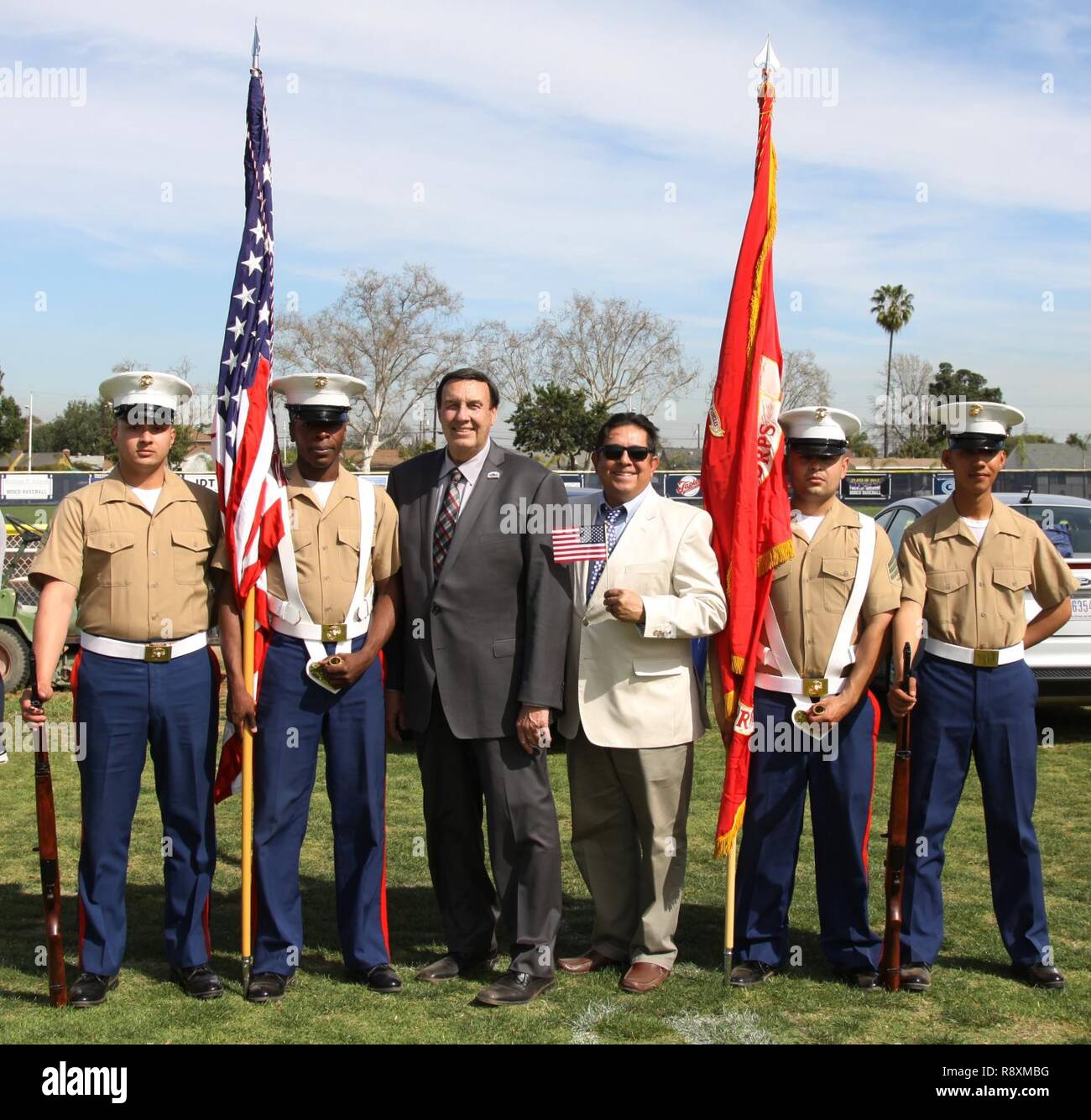 Left to right, Marine Corps Recruiters Sgt. Elijah Gable, Sgt. Derrick Berrian, the Honorable Dan Koops, Mayor of Bellflower, Calif., David Mestas, religious studies educator of St. John Bosco High School, Sgt. Victor Romualdo and LCpl. Ulixes Hernandez, pose during a varsity baseball game at St. John Bosco High School, Bellflower, Calif., March 14, 2017. Coming from Recruiting Substation Lakewood, the recruiters were the official color guard for the game. Stock Photo