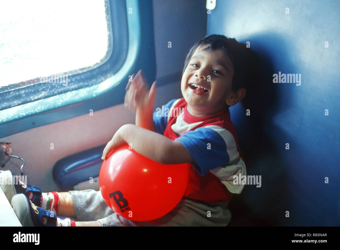 Child sitting in train compartment MR#152 Stock Photo