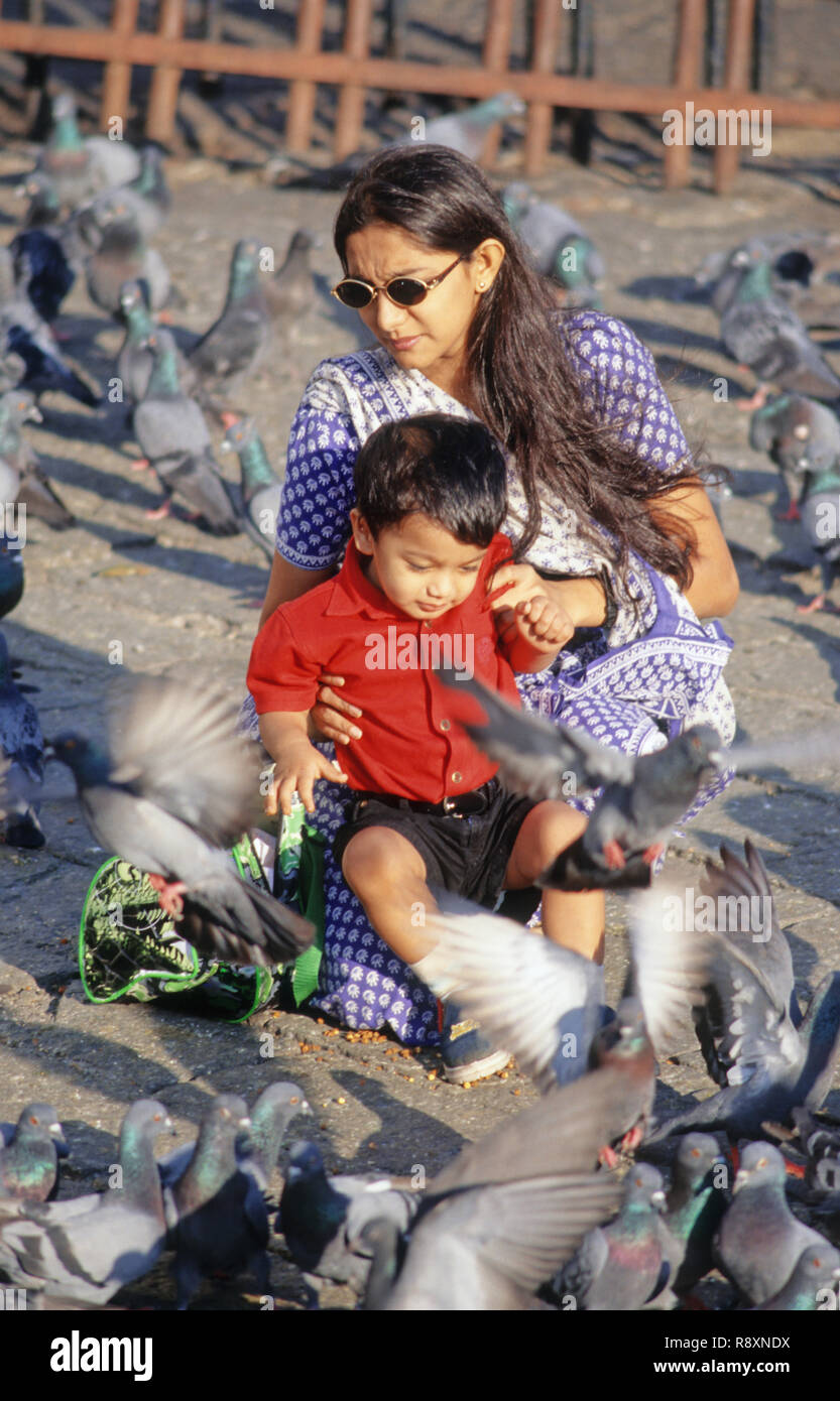 Mother and child feeding pigeons at Gateway Of India Bombay India MR#152 Stock Photo