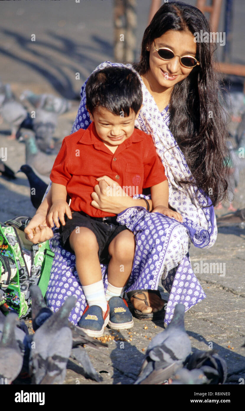 Mother and child feeding pigeons at Gateway of India Bombay India MR#152 Stock Photo
