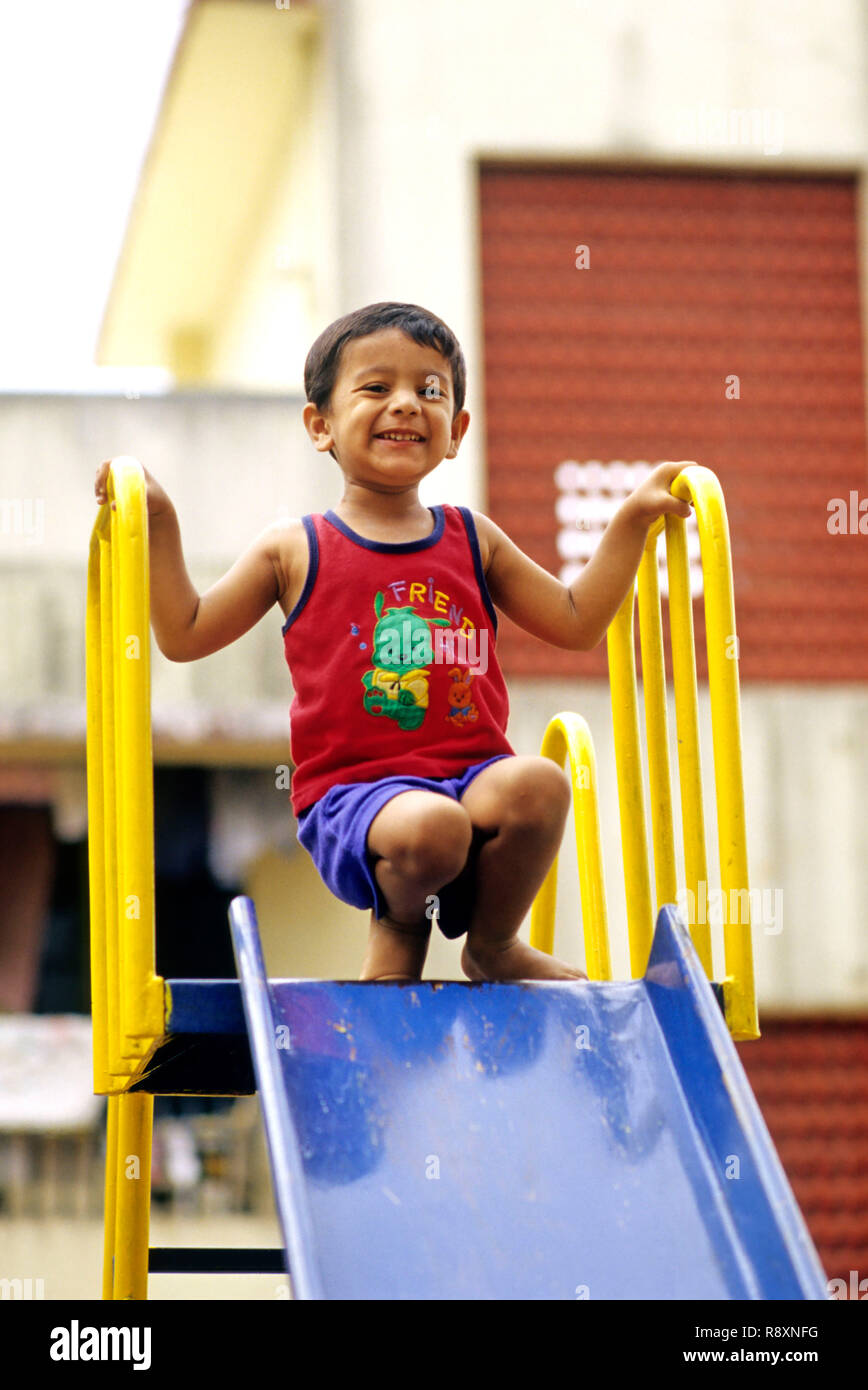 Boy playing on a slide , Stock Photo