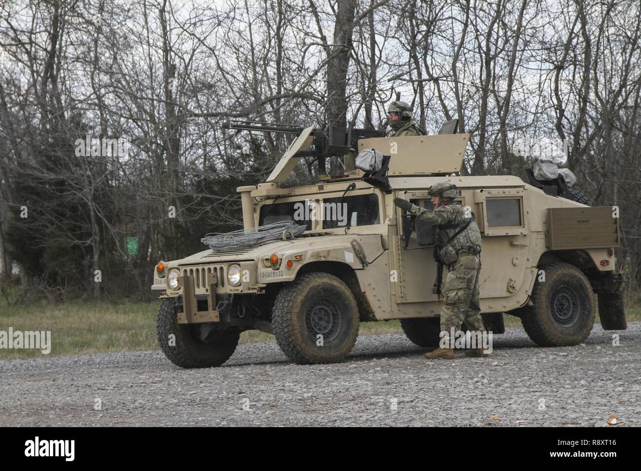 A squad leader with 1st Platoon, 194th Military Police Company, 716th MP Battalion, 101st Airborne Division (Air Assault) Sustainment Brigade, 101st Abn. Div., directs a Soldier, March 14, 2017, as the platoon establishes a traffic control point during a platoon external evaluation on Fort Campbell, Kentucky. Stock Photo