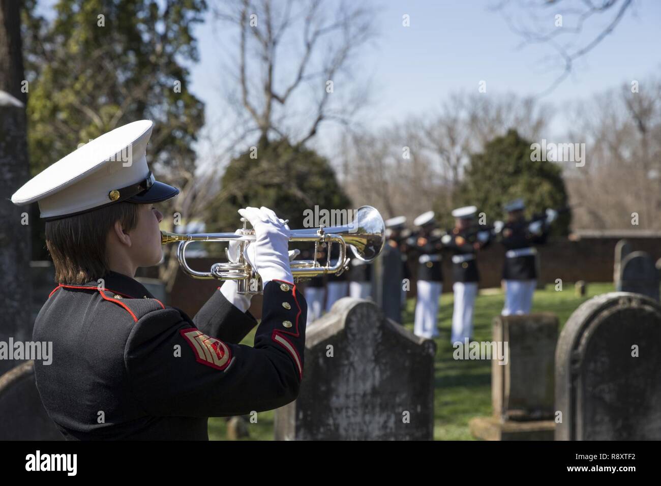 A U.S. Marine with the Marine Corps Base Quantico Marine Band, plays taps during the annual Madison wreath laying ceremony at the final resting place of the 4th President of the United States, James Madison, at his home at Montpelier, Orange, Va., March 16, 2017. This event was held in commemoration of the 266th anniversary of the birthdate of Madison, and has also been decreed as James Madison Appreciation Day for the Commonwealth of Virginia. Stock Photo