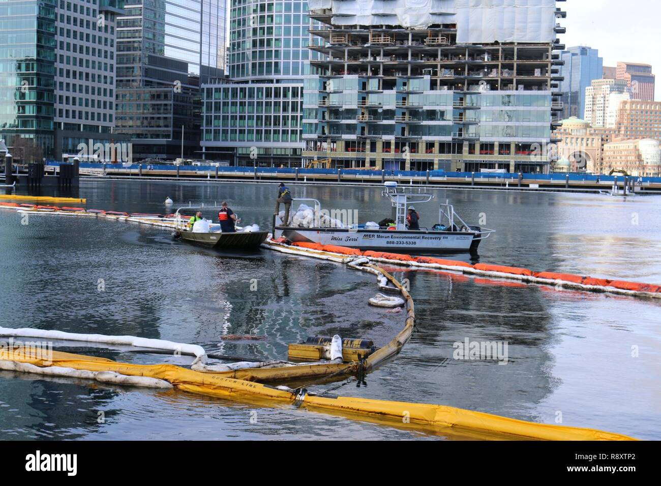 The commercial oil spill response company tends the containment boom  deployed around the wreck of the ferry Peter Stuyvesant in Boston Harbor  Saturday, Feb. 25, 2017. The harbor boom and sorbent work