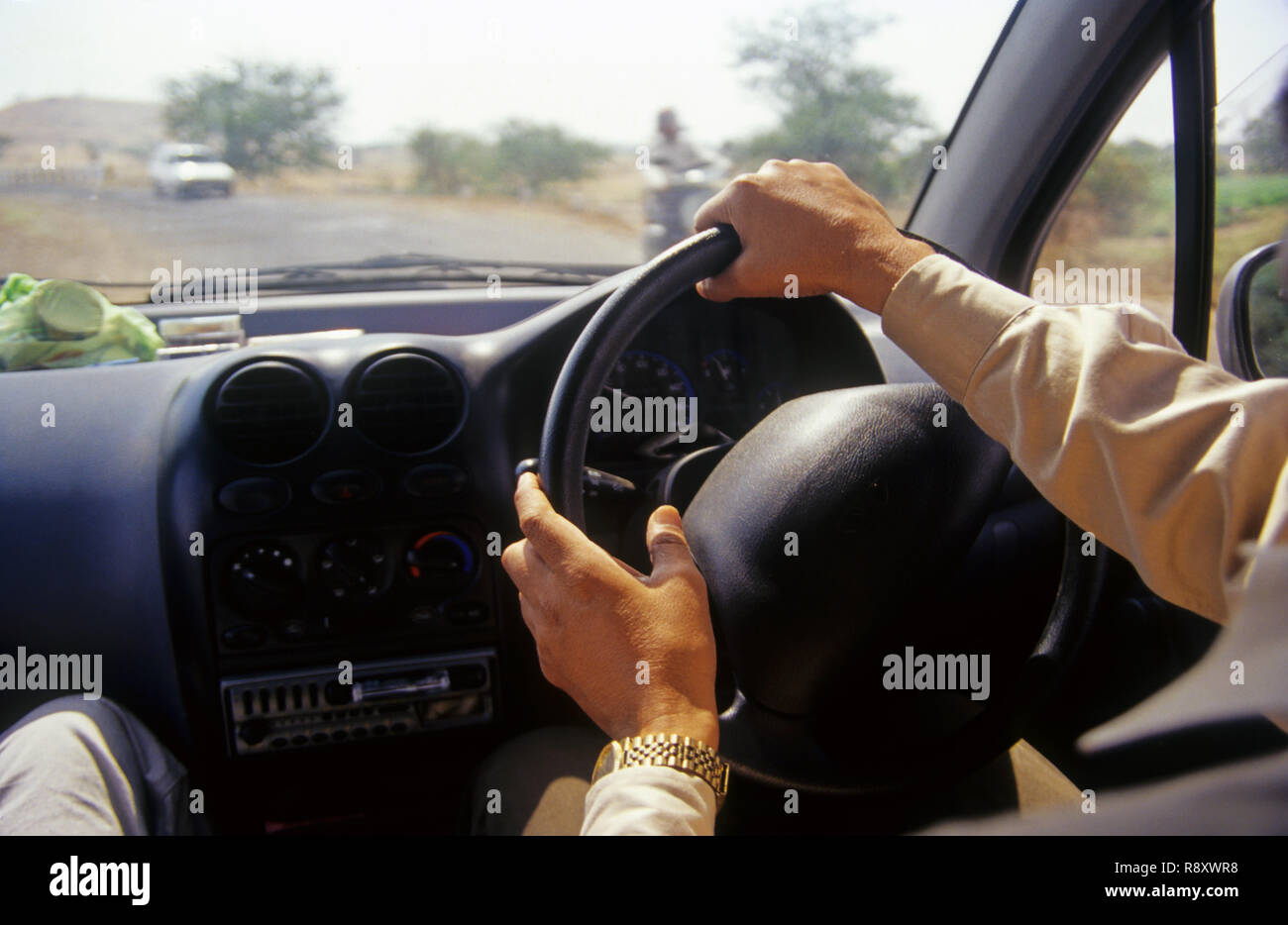 man driving car vehicle automobile hand on steering wheel Stock Photo