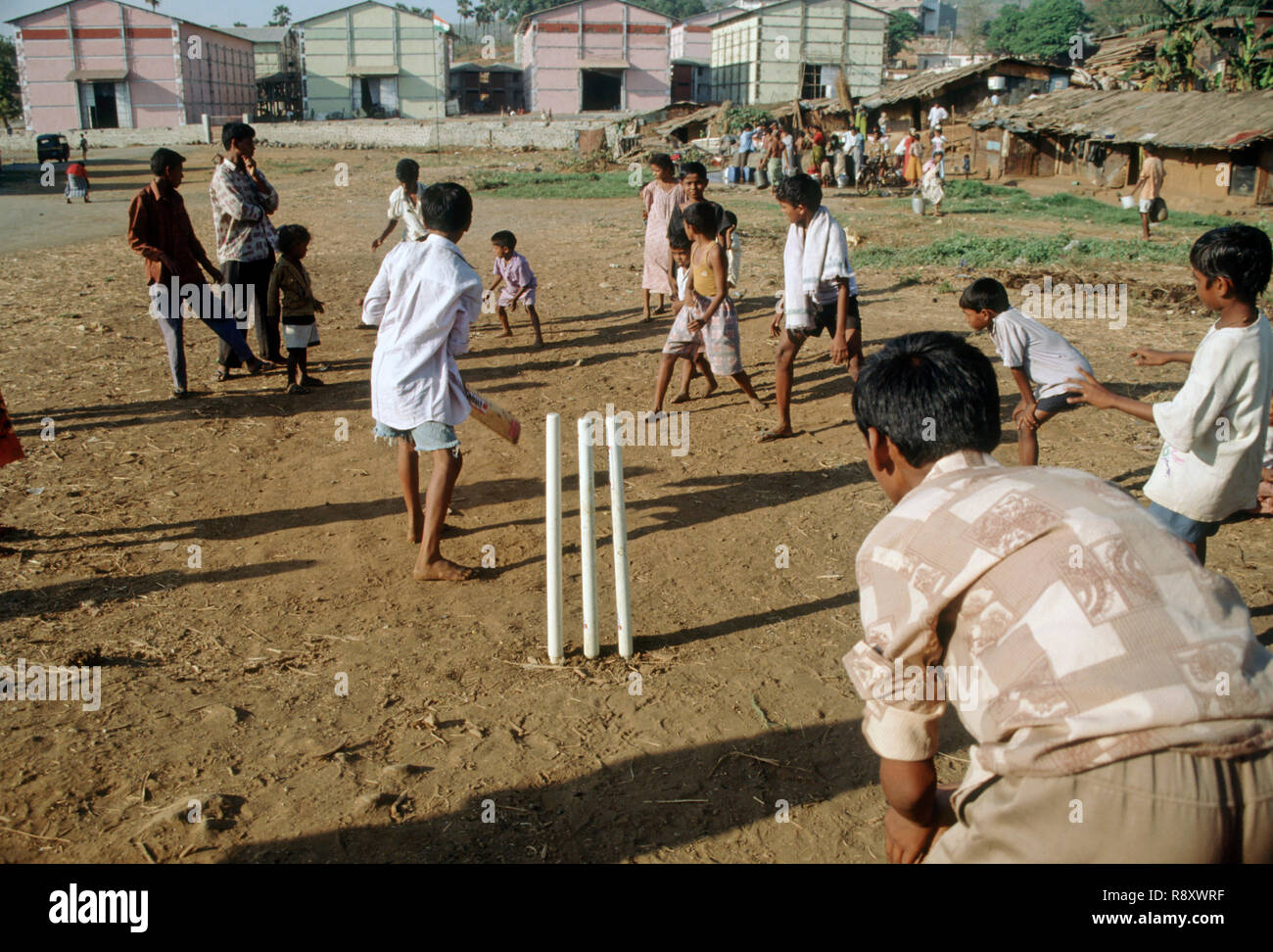 children playing cricket in slum, mumbai bombay, maharashtra, india Stock Photo