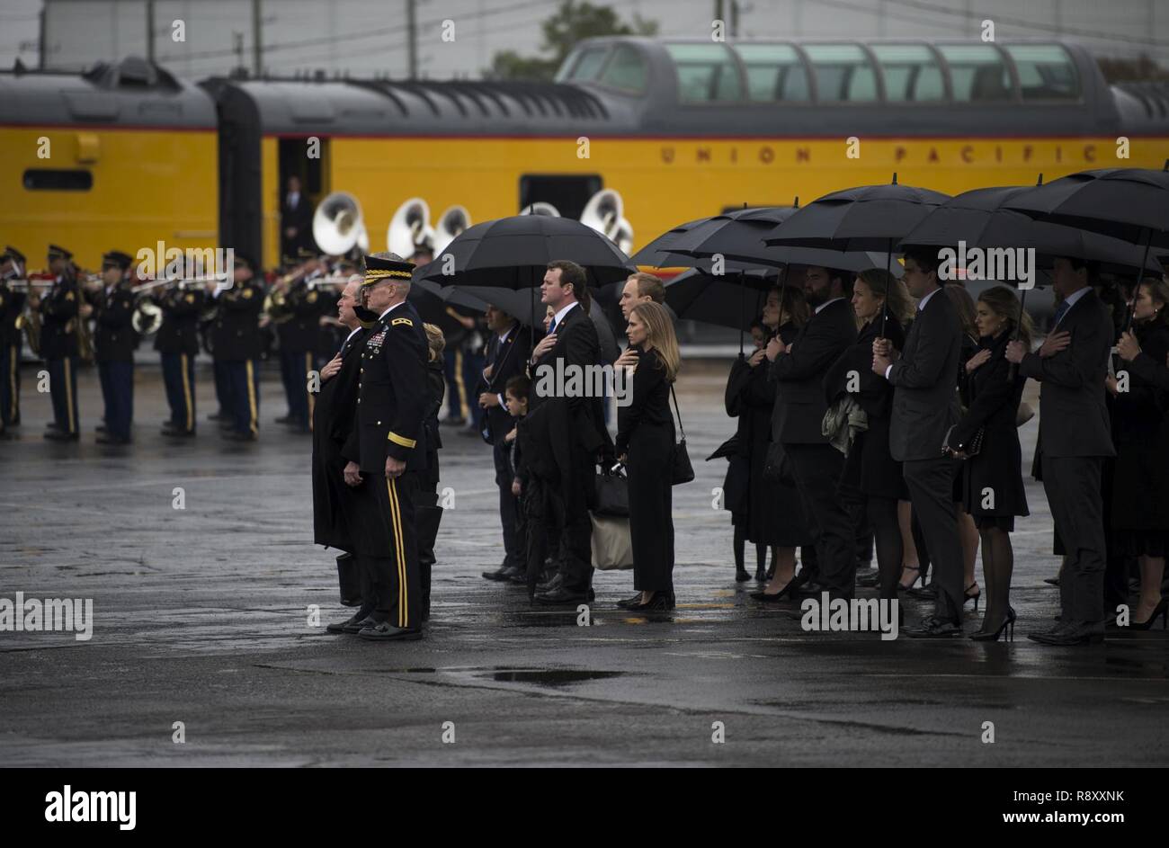 Former President George W. Bush, former First Lady Laura Bush and other family members observe as George H.W. Bush’s casket is moved to the funeral car during a departure ceremony at Union Pacific Westfield Auto Facility, Spring, Texas, Dec. 6, 2018. The funeral car was pulled by the 4141 locomotive and carried George H.W. Bush's remains toward his final resting place. Nearly 4,000 military and civilian personnel from across all branches of the U.S. armed forces, including Reserve and National Guard components, provided ceremonial support during the state funeral of George H.W. Bush, the 41st  Stock Photo