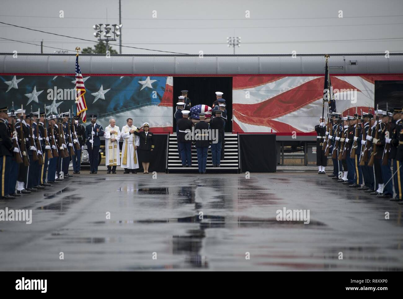 U.S. service members with the Joint Forces Honor Guard carry the casket of former U.S. President George H.W. Bush to a funeral car during a departure ceremony at Union Pacific Westfield Auto Facility, Spring, Texas, Dec. 6, 2018. The funeral car was pulled by the 4141 locomotive and carried George H.W. Bush's remains toward his final resting place. Nearly 4,000 military and civilian personnel from across all branches of the U.S. armed forces, including Reserve and National Guard components, provided ceremonial support during the state funeral of George H.W. Bush, the 41st President of the Unit Stock Photo