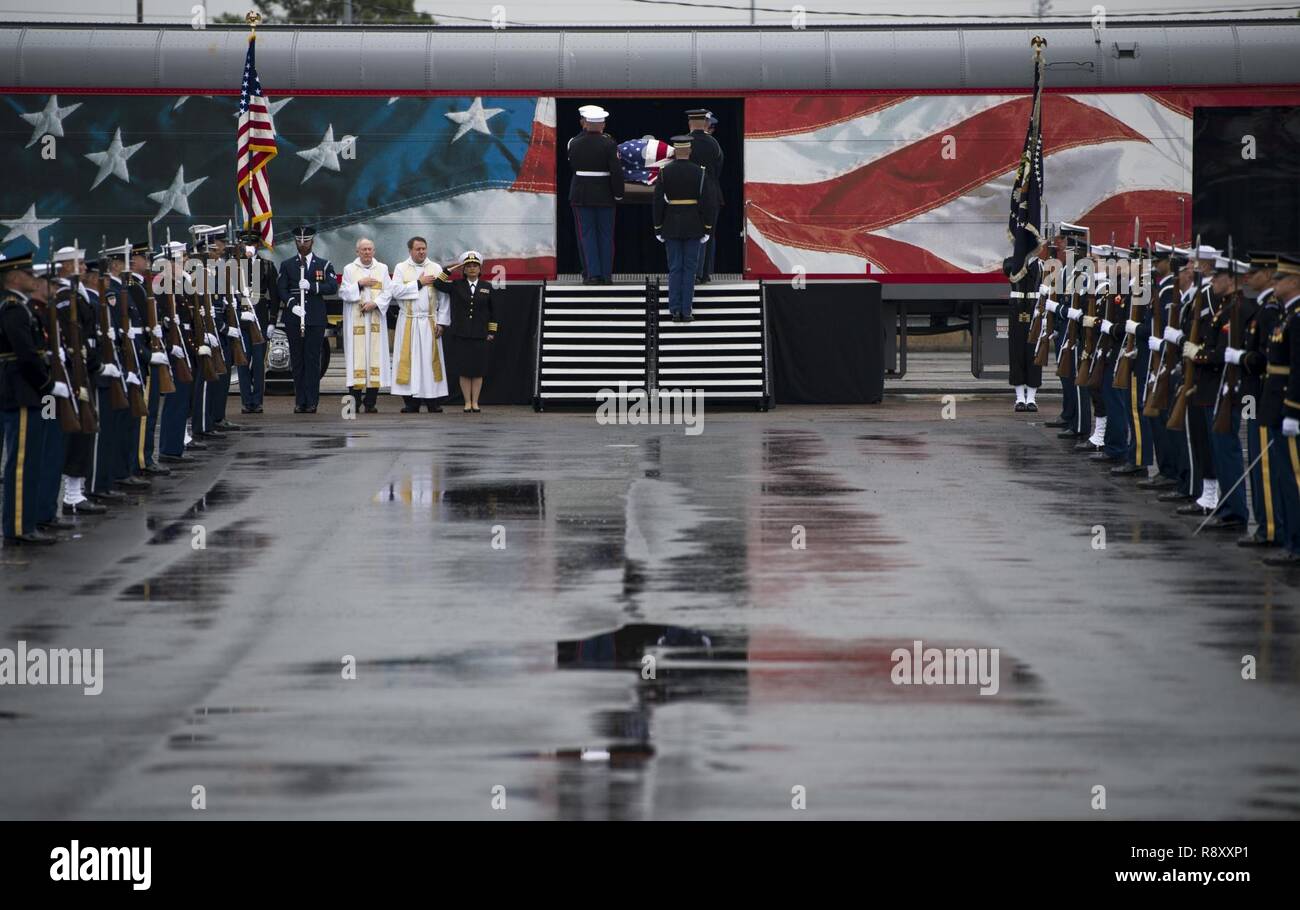 U.S. service members with the Joint Forces Honor Guard carry the casket of former U.S. President George H.W. Bush to a funeral car during a departure ceremony at Union Pacific Westfield Auto Facility, Spring, Texas, Dec. 6, 2018. The funeral car was pulled by the 4141 locomotive and carried George H.W. Bush's remains toward his final resting place. Nearly 4,000 military and civilian personnel from across all branches of the U.S. armed forces, including Reserve and National Guard components, provided ceremonial support during the state funeral of George H.W. Bush, the 41st President of the Unit Stock Photo