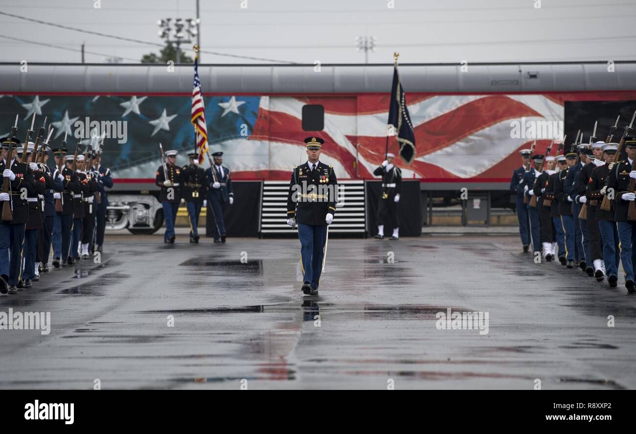U.S. service members with the Joint Forces Honor Guard participate in a departure ceremony for former President George H.W. Bush in front of the funeral car carrying the former president at Union Pacific Westfield Auto Facility, Spring, Texas, Dec. 6, 2018. The funeral car was pulled by the 4141 locomotive and carried George H.W. Bush's remains toward his final resting place. Nearly 4,000 military and civilian personnel from across all branches of the U.S. armed forces, including Reserve and National Guard components, provided ceremonial support during the state funeral of George H.W. Bush, th Stock Photo