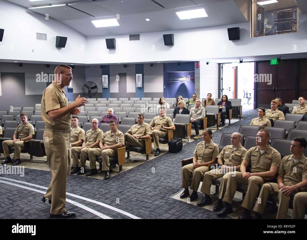 Rear Adm. Dave Welch, commander of the Naval Surface and Mine Warfighting Development Center (SMWDC), speaks with Anti-Submarine Warfare/ Surface Warfare (ASW/SUW) Warfare Tactics Instructor (WTI) Course students during the graduation ceremony. SMWDC is one of the Navy's five Warfighting Development Centers and its mission is to increase the lethality and tactical proficiency of the surface force across all domains. Stock Photo