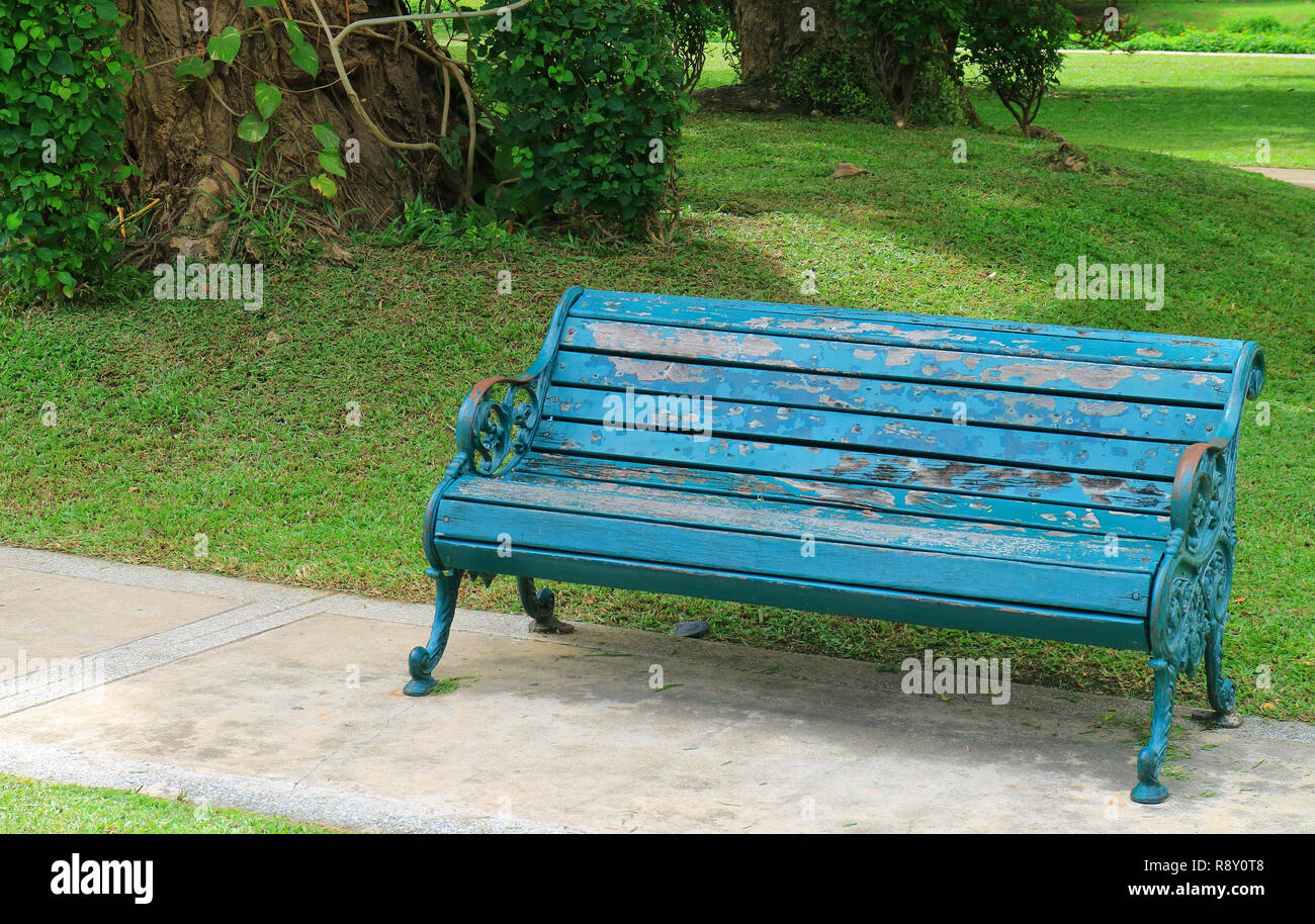 Turquoise Blue Colored Wood With Wrought Iron Bench In The Green