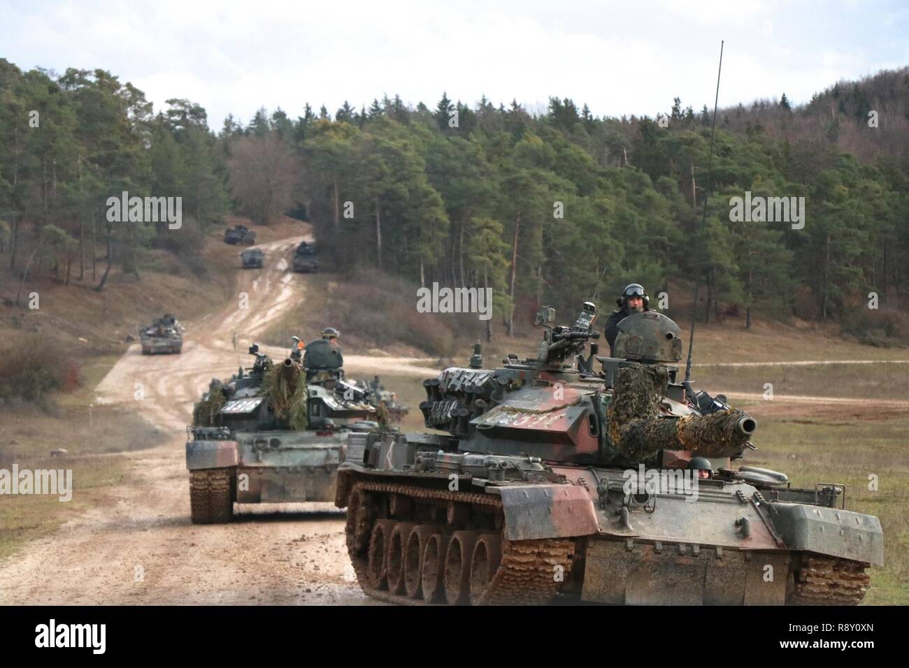 Romanian troops maneuver TR-85 tanks during Combined Resolve XI on Dec. 7, 2018 in Hohenfels, Germany. Combined Resolve XI is a biannual exercise that serves as the combat training center certification exercise for regionally allocated forces. This iteration of the exercise takes place in two phases at the Grafenwoehr and Hohenfels training areas between Nov. 26-Dec. 14, 2018 and Jan. 13-25, 2019. Stock Photo