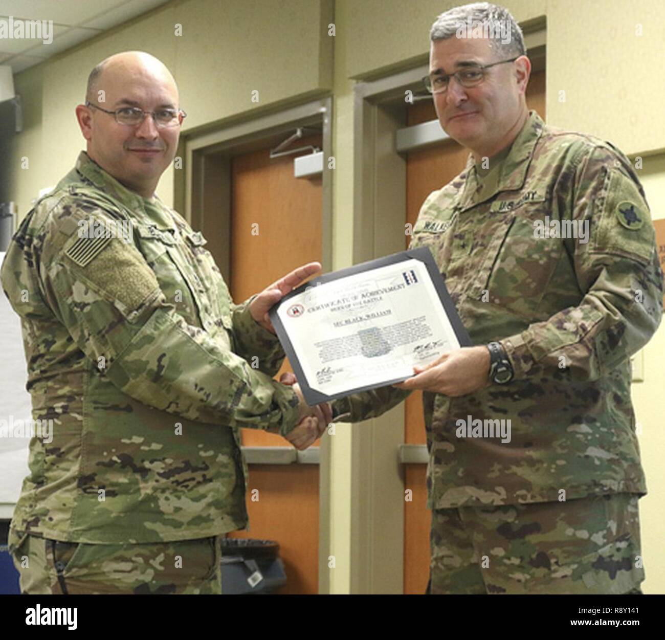 Sgt. 1st Class William Black, 184th Sustainment Command receives a Hero of The Battle certificate from Brig. Gen. Clint E. Walker, 184 SC commander. Black was awarded for his professionalism and proficiency during the units validation for the upcoming deployment. Stock Photo