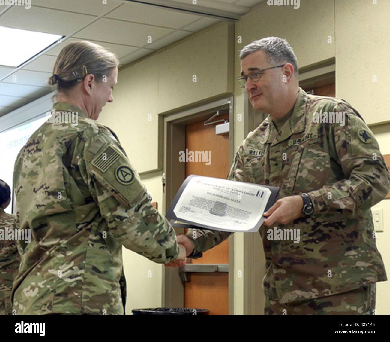 Staff Sgt. Alana Harrigill, 184th Sustainment Command receives a Hero of The Battle certificate from Brig. Gen. Clint E. Walker, 184 SC commander. Harrigill was awarded for her professionalism and proficiency during the units validation for the upcoming deployment. Stock Photo