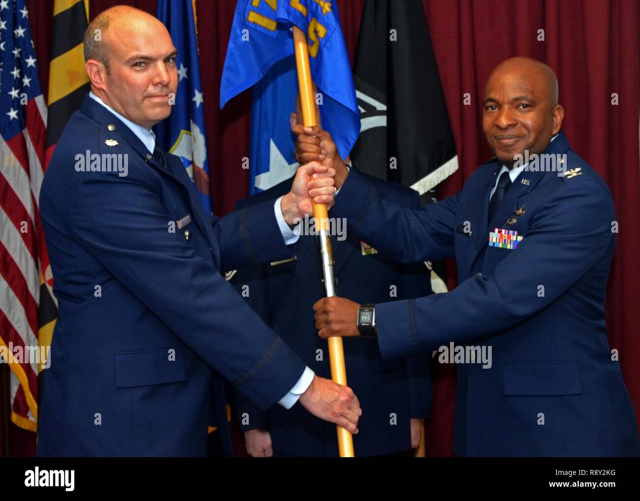 Mission Support Group commander Col. Nashid Salahuddin accepts the 175th  Logistics Readiness Squadron guidon from previous Commander Lt. Col. Steven  Harrigan during a change of command ceremony at Warfield Air National Guard