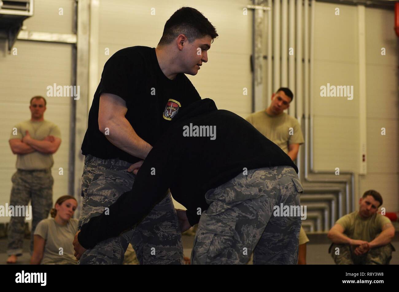 Staff Sgt. Jose Ruiz, 435th Security Forces Squadron ground combat readiness training center instructor, left, conducts a combatives class for Airmen from the 86th Security Forces Squadron and 569th U.S. Forces Police Squadron, on Ramstein Air Base, Germany, March 2, 2017. The 435th SFS conducts the Fly Away Security Training program for Airmen providing security for aircraft. FAST instructors aim to help prepare security forces Airmen for scenarios they may face while on a mission. Stock Photo