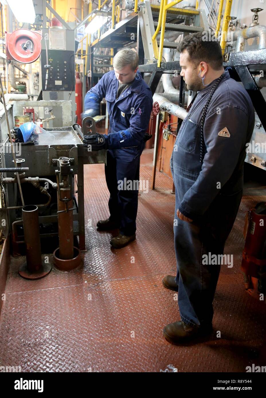 ATLANTIC OCEAN (February 21, 2017)--Engine Cadet Victoria Jones, a midshipment at the United States Merchant Marine Academy, performs miantenance on a boiler barrel in the engin room of Military Sealift Command's hospital ship USNS Comfort (T-AH 20), Feb. 21. Six midshipment are currently attached to Comfort as part of their 'Sea Year' which is designed to provide cadets with practical training. Stock Photo