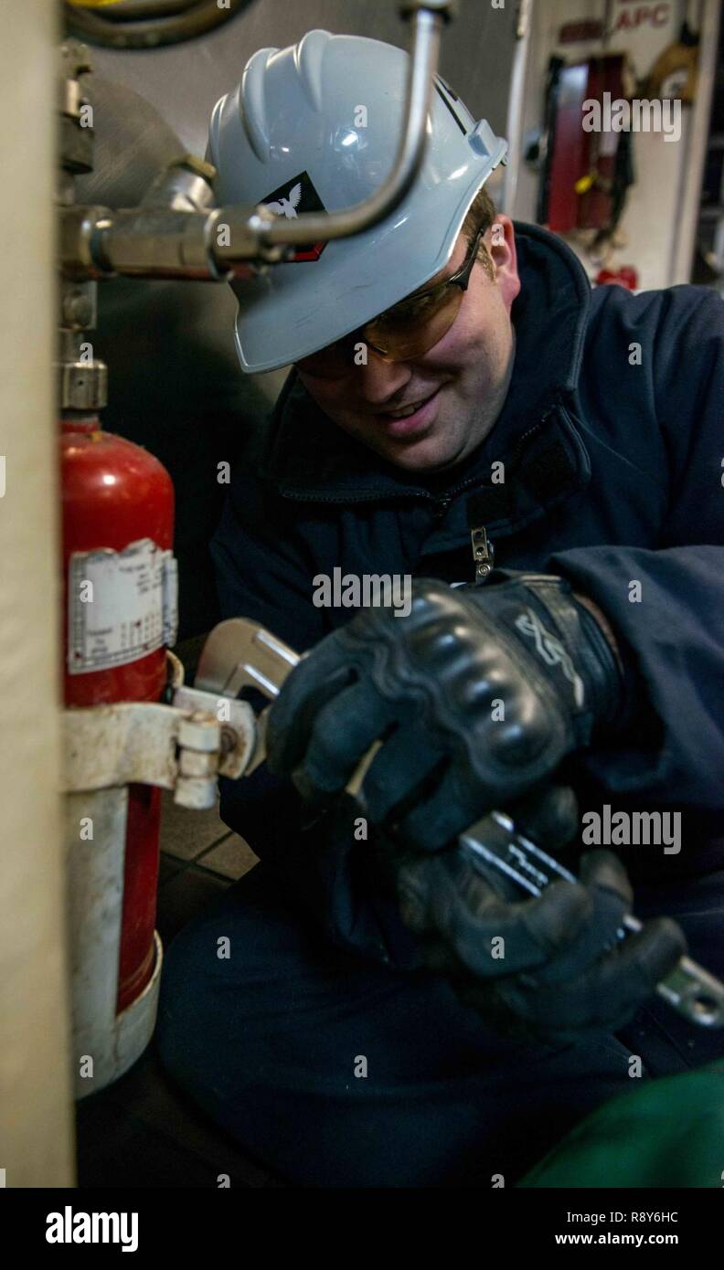 BREMERTON, Washington (March 6, 2017) Damage Controlman 3rd Class Cody Abbott, from Lindstrom, Minnesota, removes an aqueous potassium carbonate bottle from the mess decks as part of galley upgrades aboard USS John C. Stennis (CVN 74). John C. Stennis is conducting a planned incremental availability (PIA) at Puget Sound Naval Shipyard and Intermediate Maintenance Facility, during which the ship is undergoing scheduled maintenance and upgrades. Stock Photo