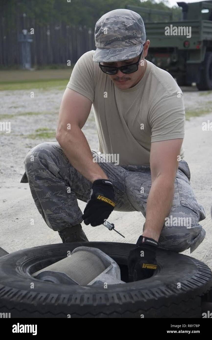 U.S Air Force Tech. Sgt. Darren C. Clemen, a 624th Civil Engineer Squadron power production specialist, practices installing a tape connector for the Mobile Aircraft Arresting System during Silver Flag at Tyndall Air Force Base, Fla., Feb. 28, 2017. Airmen with the power production shop train on the MAAS, which can rapidly decelerate an aircraft in case of a malfunction. Located on Oahu and a component of the Air Force Reserve, the 624th CES is comprised of three PRIME BEEF teams, seven Firefighting teams and one Readiness team, which support the 624th Regional Support Group's mission to deliv Stock Photo