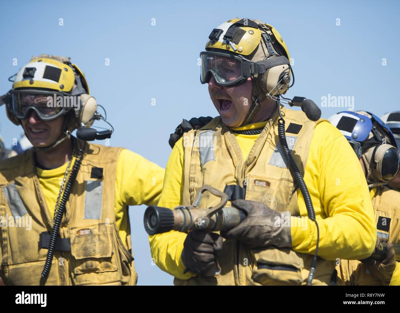 U.S. 5TH FLEET AREA OF OPERATIONS (March 8, 2017) Aviation Boatswain’s Mate (Handling) Airman Caleb Lambert, from Modesto, Calif., leads a hose team during an aviation fire drill aboard the amphibious assault ship USS Makin Island (LHD 8). Makin Island is deployed in the U.S. 5th Fleet area of operations in support of maritime security operations designed to reassure allies and partners, and preserve the freedom of navigation and the free flow of commerce in the region. Stock Photo
