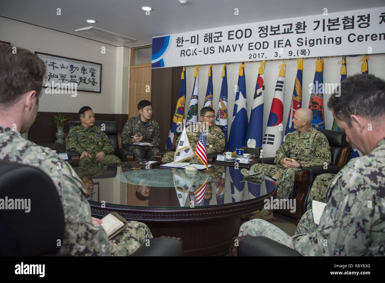 Commander, Task Force 75, U.S. Navy Capt. Robert A. Baughman, and Commander, Republic of Korea (ROK) Naval Special Warfare Flotilla, Rear Adm. Jae Eun Lee, speak during an information exchange agreement signing in Jinhae, ROK, March 9, 2017, as part of exercise Foal Eagle 2017. The agreement addresses research and development practices between the two nations, promotes explosive ordnance disposal interoperability, and enhances future readiness. Stock Photo