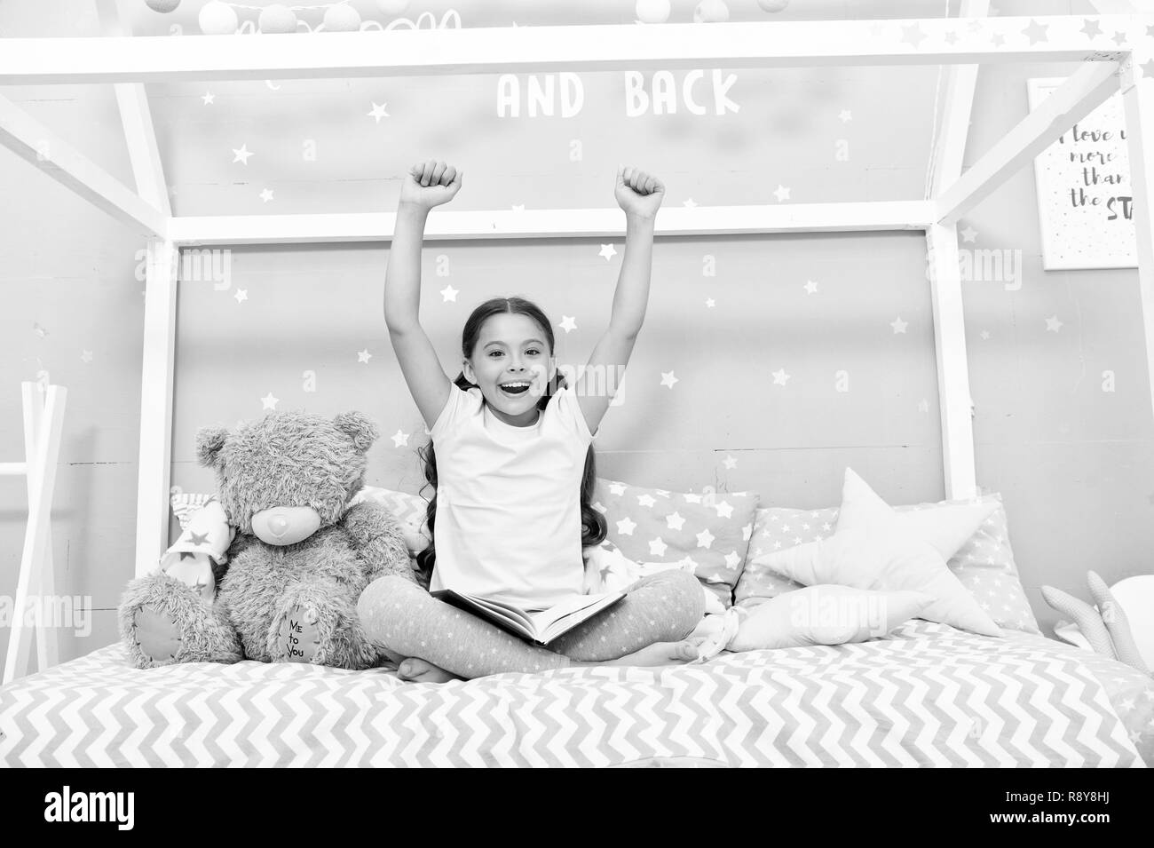 Enjoy concept. Happy girl enjoy staying in bed. Little child with