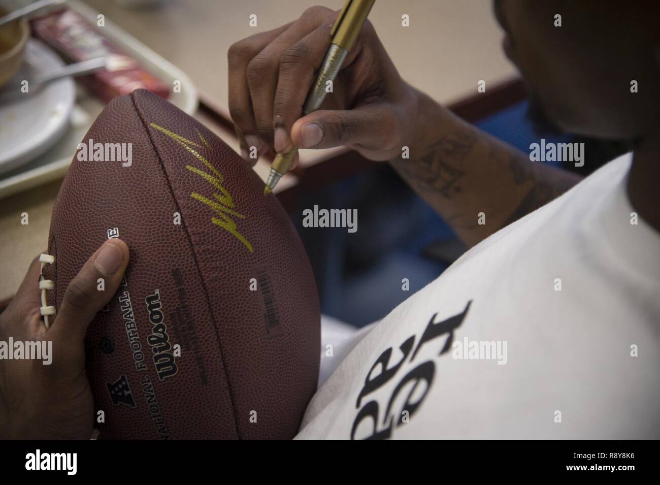 Malcolm Mitchell, right, New England Patriots’ wide receiver and Super Bowl LI Champion, signs a football during a visit March 7, 2017, at Moody Air Force Base, Ga. Mitchell, who is a Valdosta native, got a glimpse of a typical day in the life of some of Moody’s Airmen from the 23d Fighter Group, 23d Maintenance Group, 23d Mission Support Group, and the 820th Base Defense Group. During his visit, Mitchell also spent time with local Patriots’ fans. Stock Photo