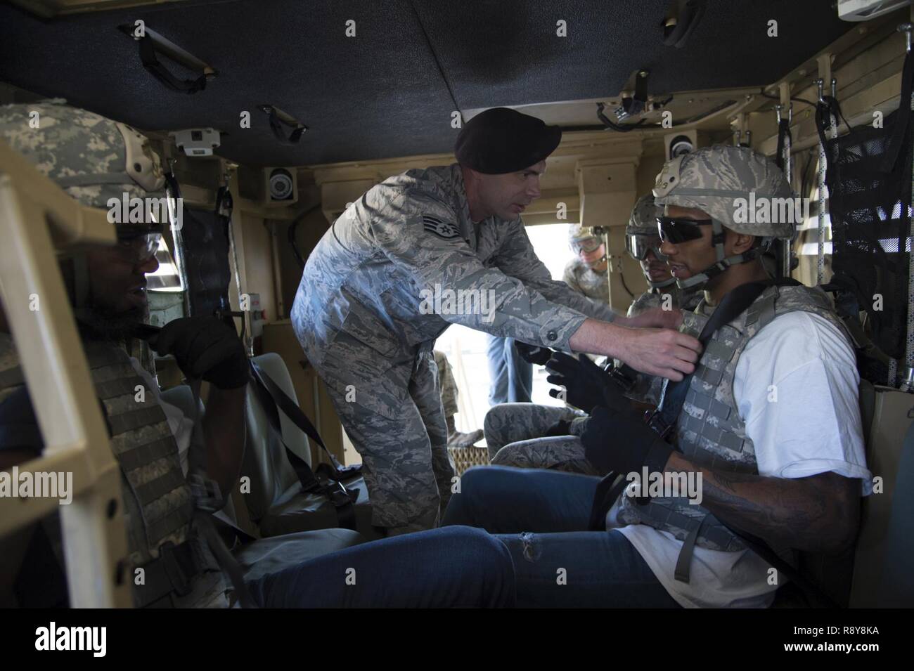 Staff Sgt. Kevin Weier, 820th Combat Operations Squadron, checks the seatbelt of Malcolm Mitchell, New England Patriots’ wide receiver and Super Bowl LI Champion, prior to a rollover demonstration in the Mine-Resistant Ambush-Protected Egress Trainer during a visit March 7, 2017, at Moody Air Force Base, Ga. Mitchell, a Valdosta native, got a glimpse of a typical day in the life of Moody Airmen. Mitchell also spent time with Airmen and signed autographs for local Patriots’ fans during his visit. Stock Photo