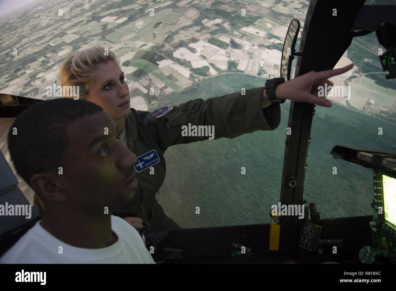 Capt. Kayla Foster, 74th Fighter Squadron A-10C Thunderbolt II pilot, gives instruction to Malcolm Mitchell, New England Patriots’ wide receiver and Super Bowl LI Champion, on operating the A-10 simulator during a visit March 7, 2017, at Moody Air Force Base, Ga. Mitchell, a Valdosta native, got a glimpse of a typical day in the life of Moody Airmen. Mitchell also spent time with Airmen and signed autographs for local Patriots’ fans during his visit. Stock Photo