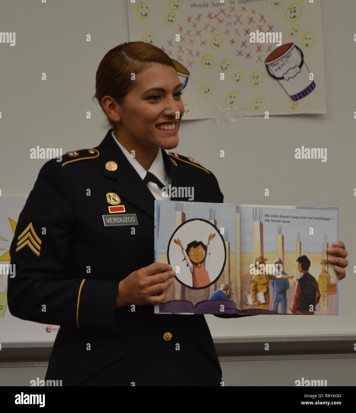 U.S. Army Reserve Sgt. Ana Verduzco with the 4th Sustainment Command (Expeditionary) reads “Hero Mom” to students at Kinder Ranch Elementary in San Antonio, TX, Mar. 10, 2017. Stock Photo