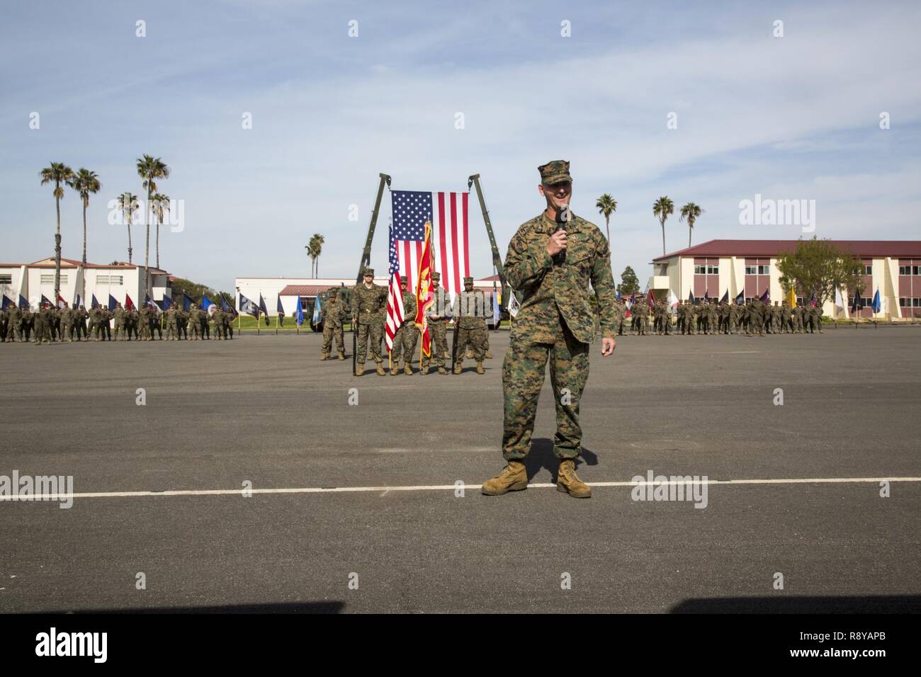 U.S. Marine Corps Col. Chandler Nelms, commanding officer of the 13th Marine Expeditionary Unit, gives his remarks during a relief and appointment ceremony at the Del Mar parade deck aboard Marine Corps Base Camp Pendleton, Calif., March 10, 2017. The ceremony was held to post Sgt. Maj. Brian Priester, relieve and retire Sgt. Maj. William Slade after 30 years of faithful military service. Stock Photo