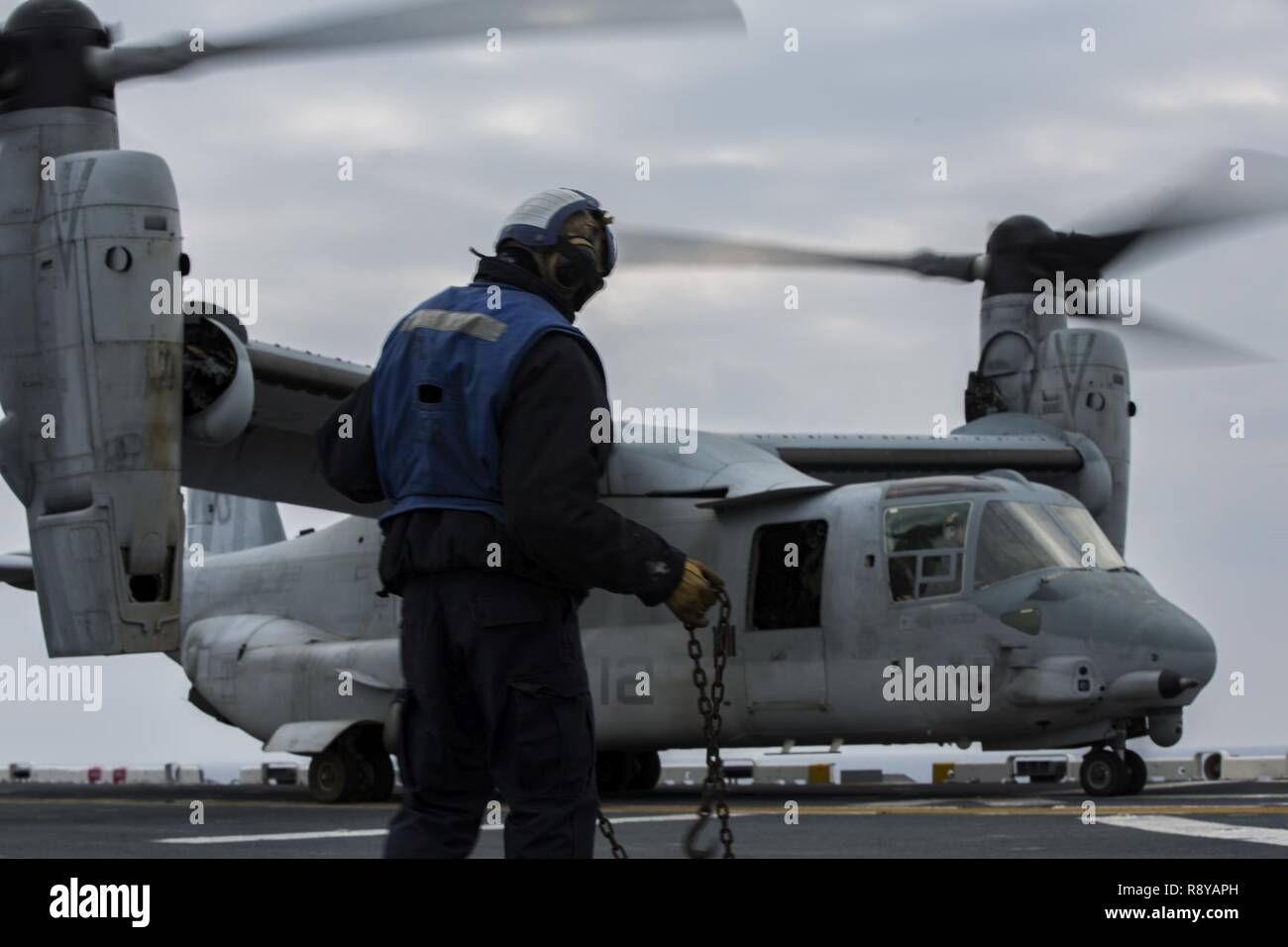 An MV-22B Osprey with Marine Medium Tiltrotor 262 (Reinforced), 31st Marine Expeditionary Unit starts propellers during flight operations in the Pacific Ocean aboard the USS Bonhomme Richard (LHD 6), March 9, 2017. Marines and Sailors of the 31st MEU embarked aboard the USS Bonhomme Richard (LHD 6), part of the Bonhomme Richard Amphibious Readiness Group, as part of their annual spring patrol of the Indo-Asia-Pacific region. The 31st MEU, embarked on the amphibious ships of the Expeditionary Strike Group 7, has the capability to respond to any crisis or contingency at a moment’s notice. Stock Photo