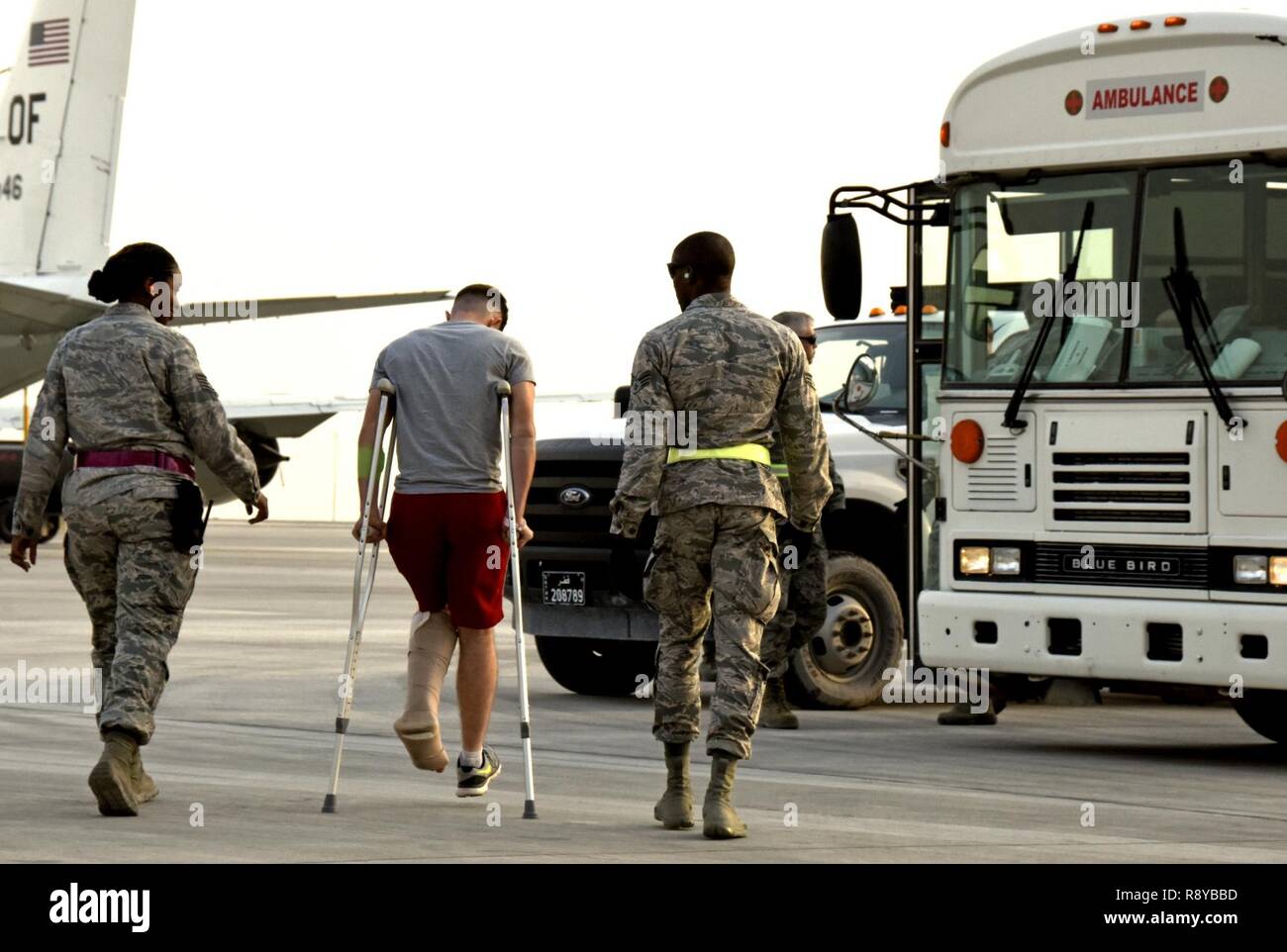 Aerospace medical technicians with the 379th Expeditionary Medical Group escort a patient from an aircraft at Al Udeid Air Base, Qatar, March 8, 2017. These technicians are a key component of transportation and support services between arrival and departure of patients from around the U.S. Central Command area of responsibility. Stock Photo