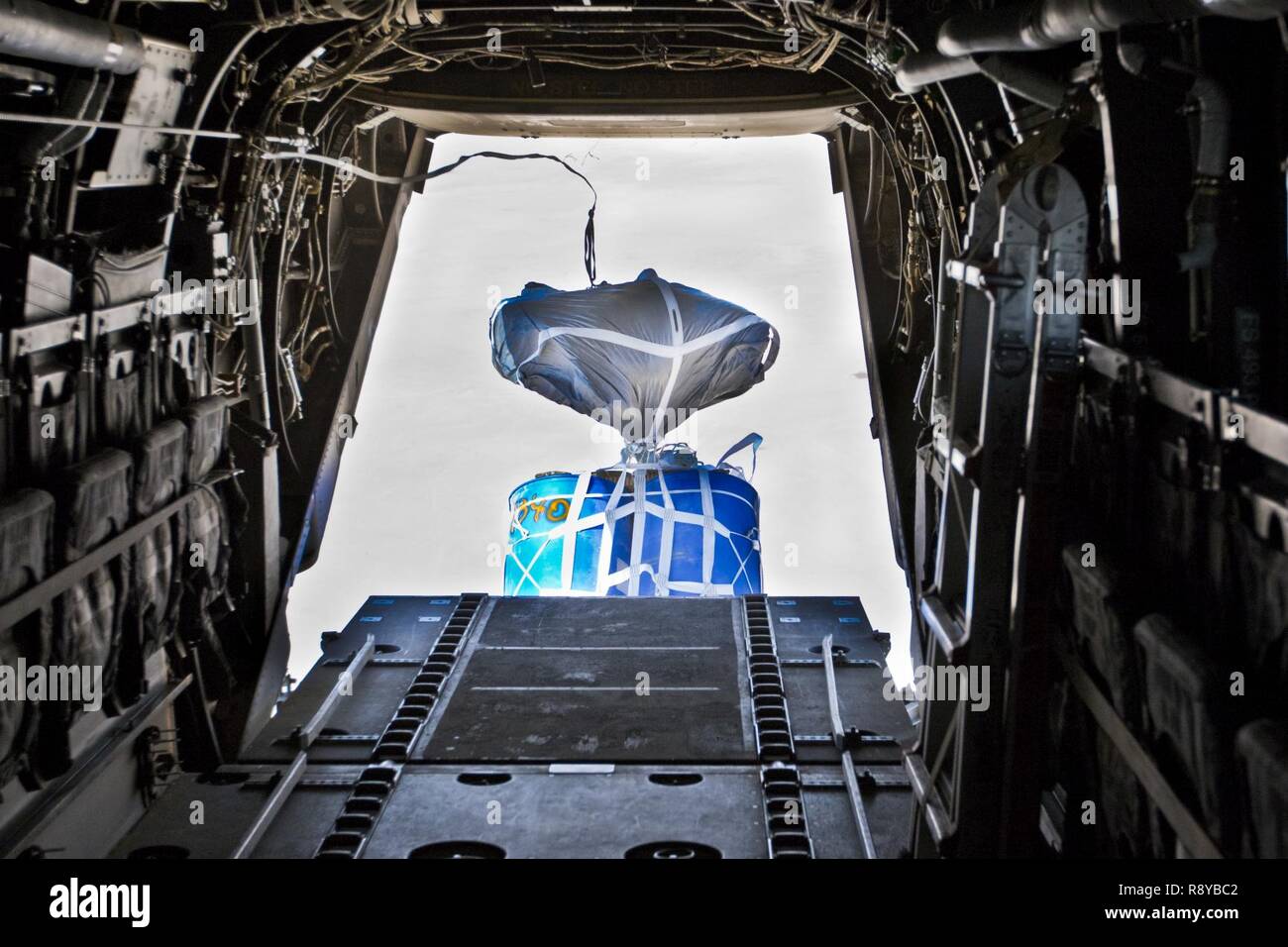 A container delivery system (CDS) airdrops out the back of a Marine