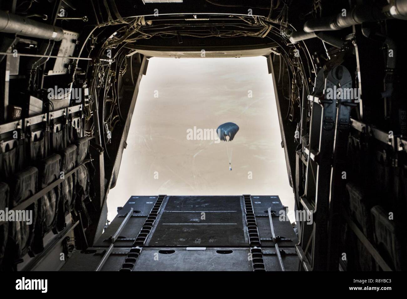 A container delivery system (CDS) airdrops out the back of a Marine