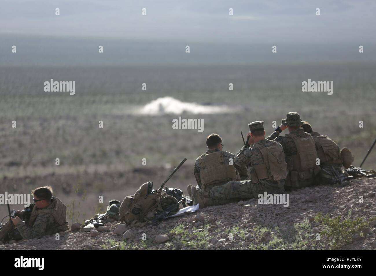 U.S. Marines with 1st Battalion, 5th Marine Regiment attached to the 15th Marine Expeditionary Unit (MEU) observe a simulated target during a Fire Support Coordination Exercise (FSC-EX) Marine Air Ground Task Force Training Center Twentynine Palms, Calif., March 7, 2017. FSC-EX is part of the 15th MEU’s Realistic Urban Training, which is the MEU’s final land-based training exercise before the first at-sea period with the America Amphibious Ready Group. The Marines of the 15th MEU undergo a series of advanced training exercises to ensure all elements of the 15th MEU are prepared to confront any Stock Photo