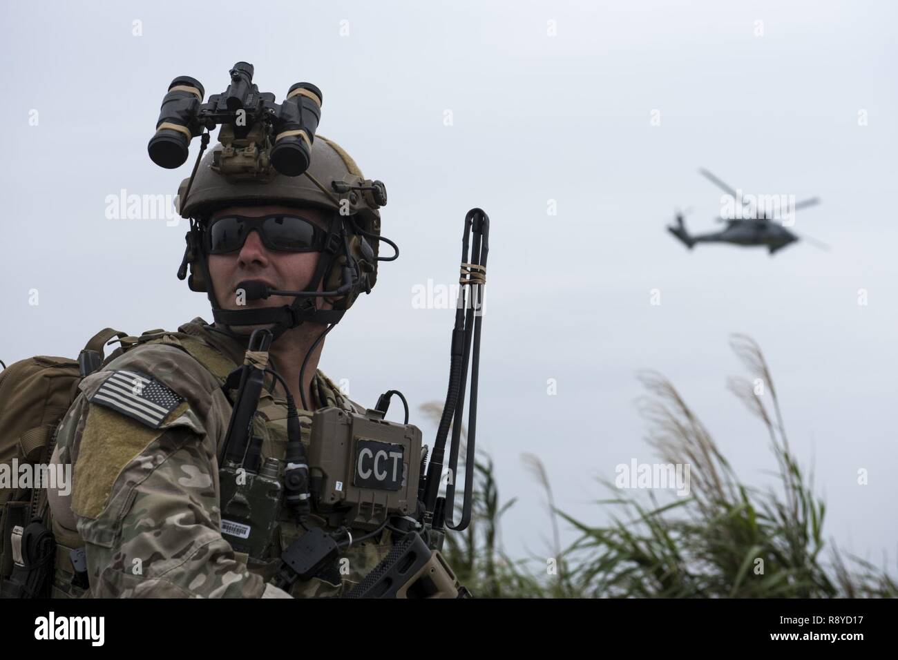 A U.S. Air Force combat control Airman from the 320th Special Tactics  Squadron communicates with a U.S. Navy HH-60 Sea Hawk from the Helicopter  Sea Combat Unit 12 during a training exercise