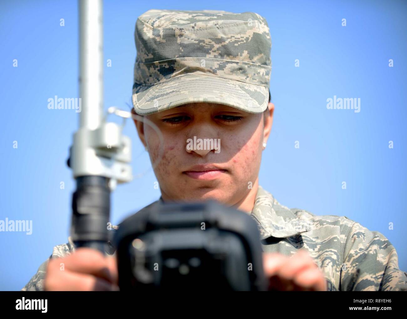 U.S. Air Force Airman Gabrielle Victor, 633rd Civil Engineer Squadron engineering technician, performs an optical site survey, at Joint Base Langley-Eustis, Va., March 9, 2017. Victor is a member of the mapping section, which produces 35 individual maps on a day-to-day basis that range from utility to airfield and environmental maps. Stock Photo