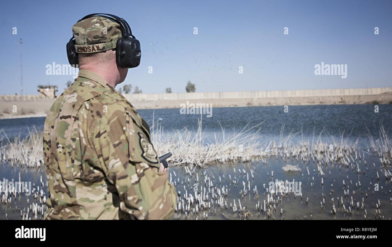 Maj. Benjamin Lindsay, 455th Air Expeditionary Wing Kandahar Airfield flight safety manager, fires birdshot to frighten away a flock of birds March 11, 2017 at Kandahar Airfield, Afghanistan. In 2015, bird strikes cost the Air Force $86 million in aircraft damages, nearly $250,000 of that at Kandahar Airfield alone. Stock Photo