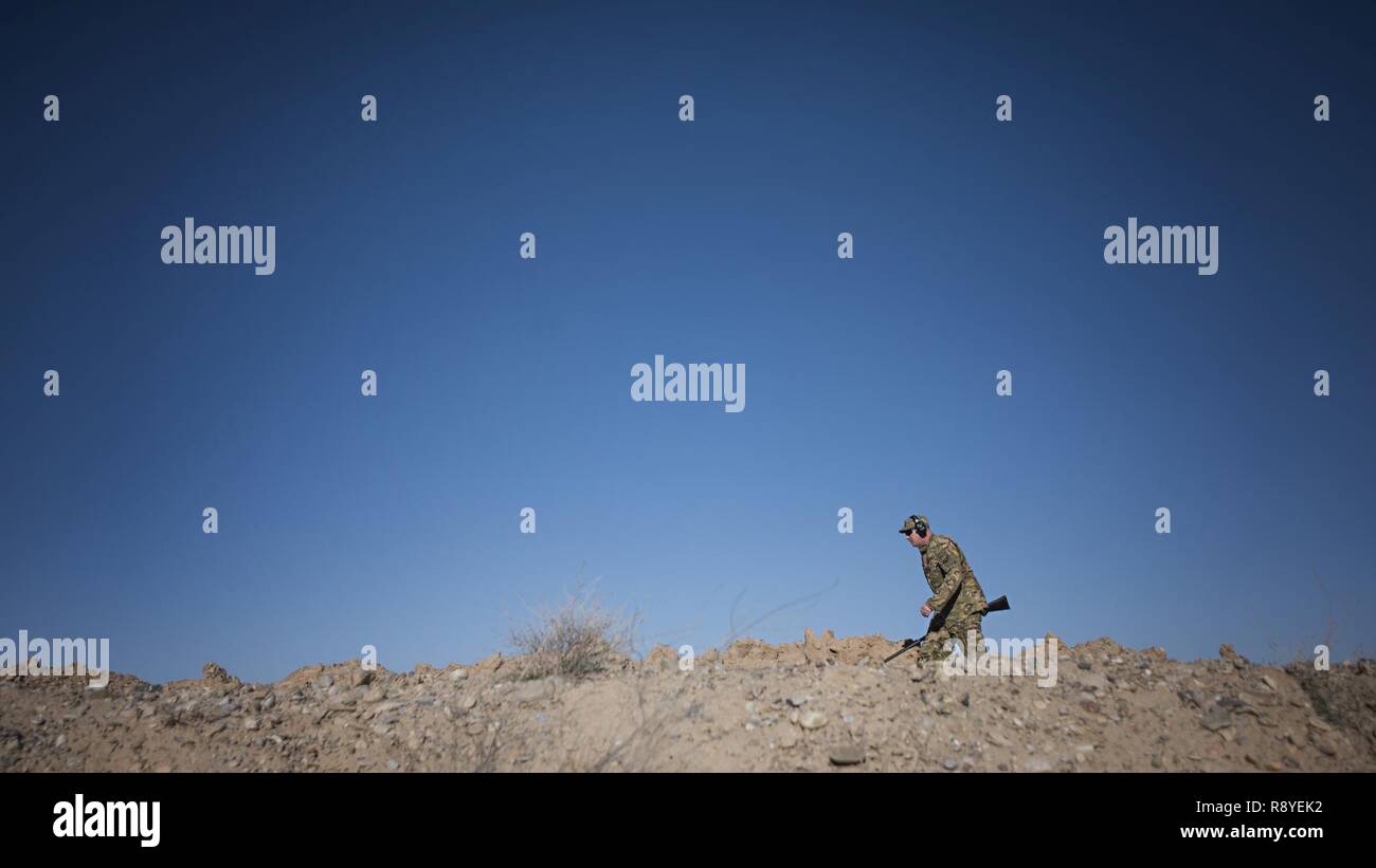 Maj. Benjamin Lindsay, 455th Air Expeditionary Wing Kandahar Airfield flight safety manager, patrols the base looking for hazardous wildlife March 11, 2017 at Kandahar Airfield, Afghanistan. Safety officials are entering into Bird Aircraft Strike Hazard Phase 2 to raise awareness and mitigate the increased threat wildlife poses to aircraft and their pilots during Spring migration season. Stock Photo